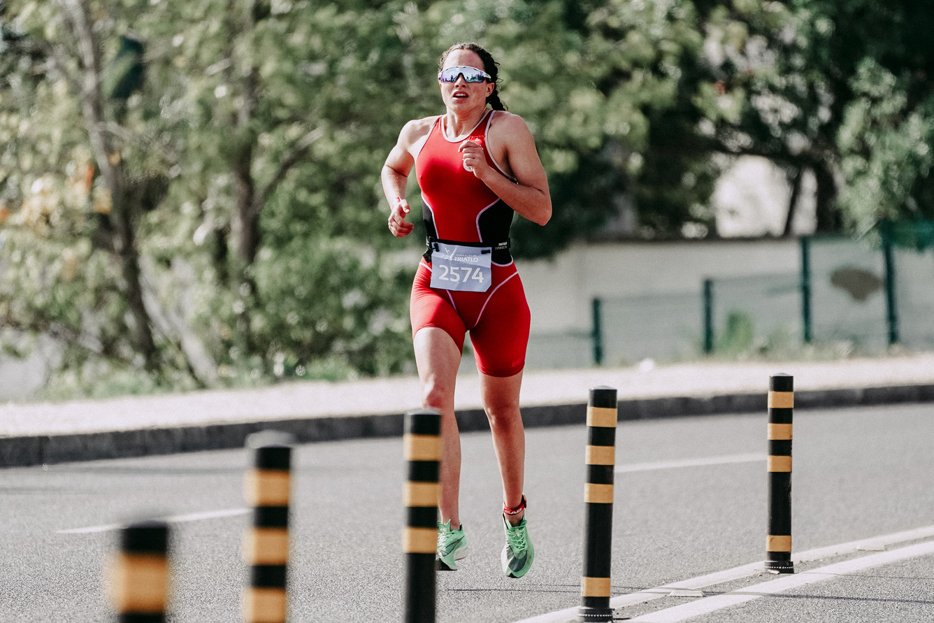 Sporty woman running on asphalt road